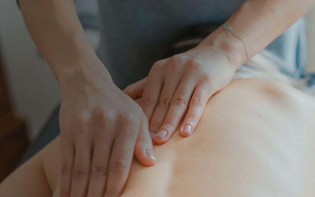 Hands massaging a back on the Sports Massage Therapy course