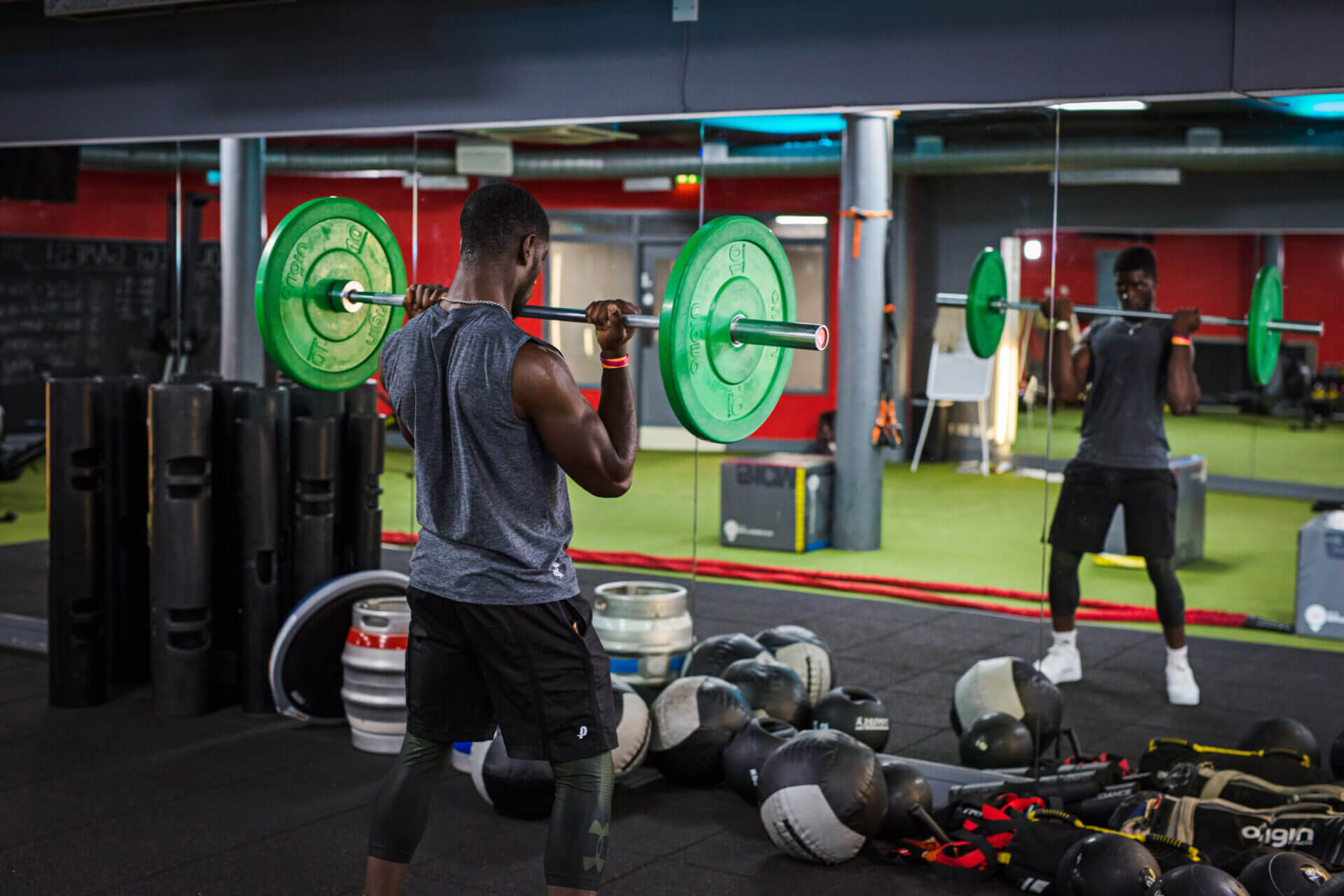 Person lifting weights in the Leeds City College gym - Fitness Instructing and Personal training