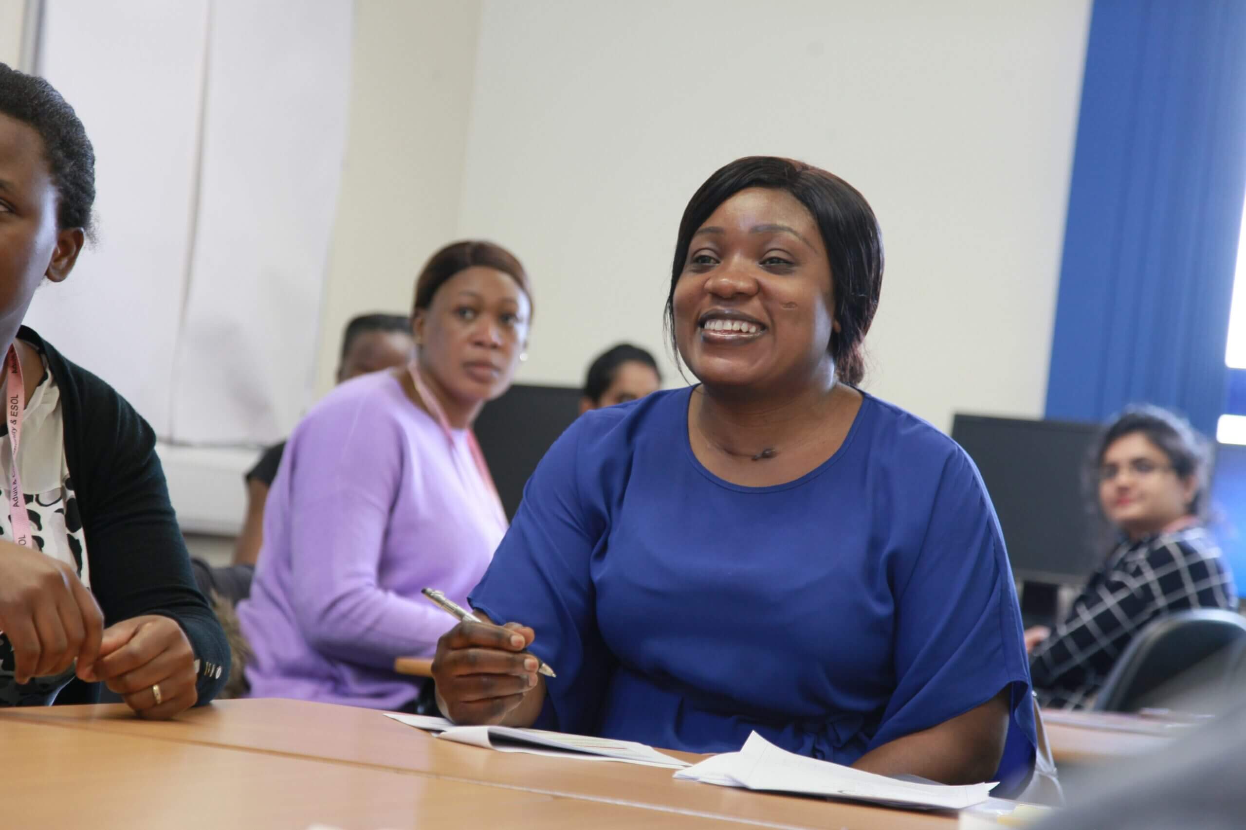 Adult learners in the classroom smiling
