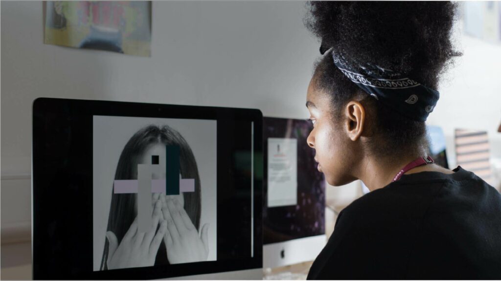 Creative Arts student working on a Graphic Design project in a mac studio