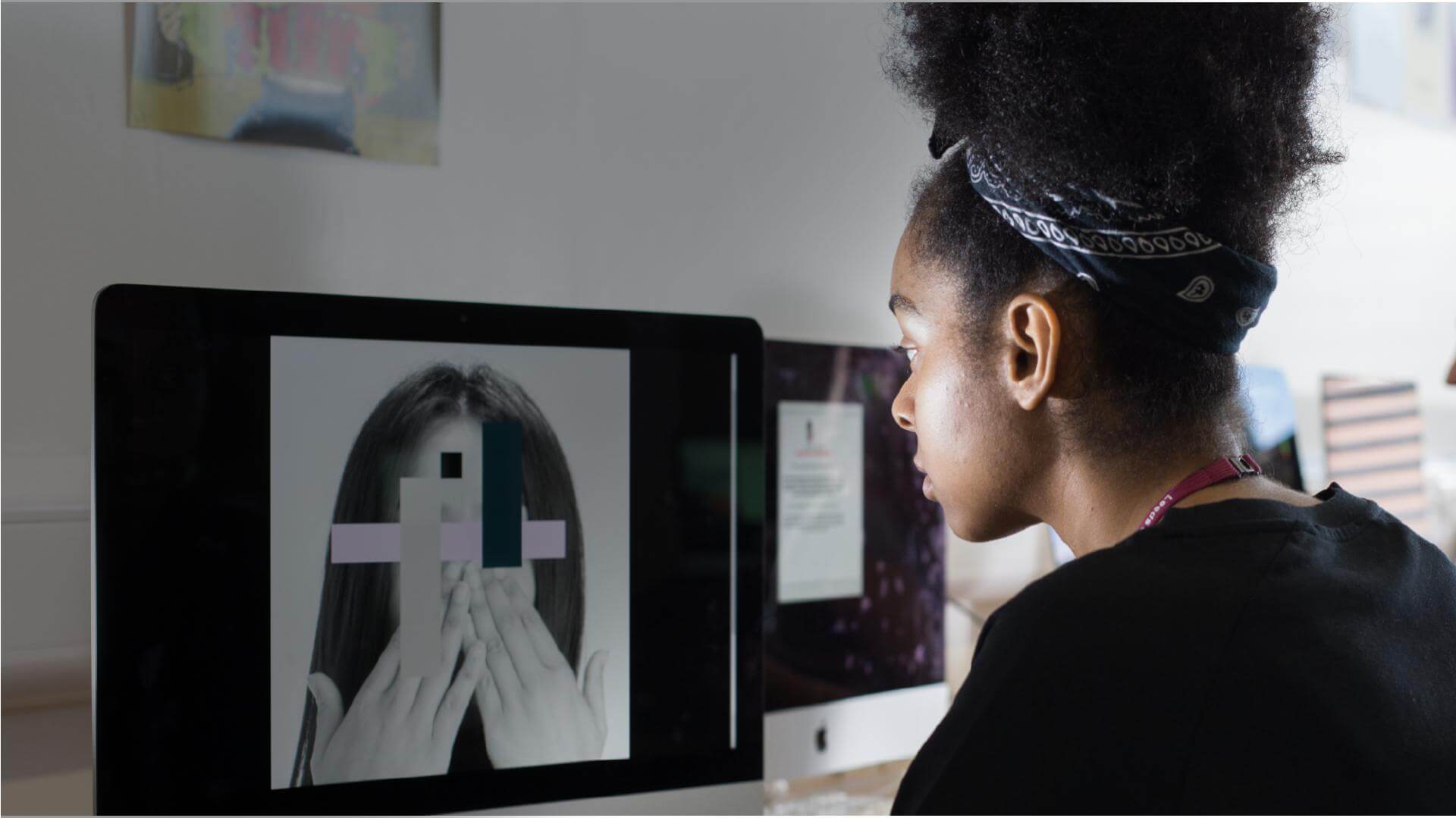 Creative Arts student working on a Graphic Design project in a mac studio
