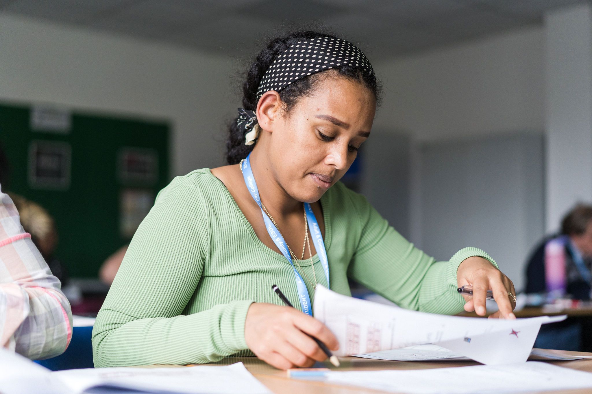 Adult learner in Deacon House reading an exam paper