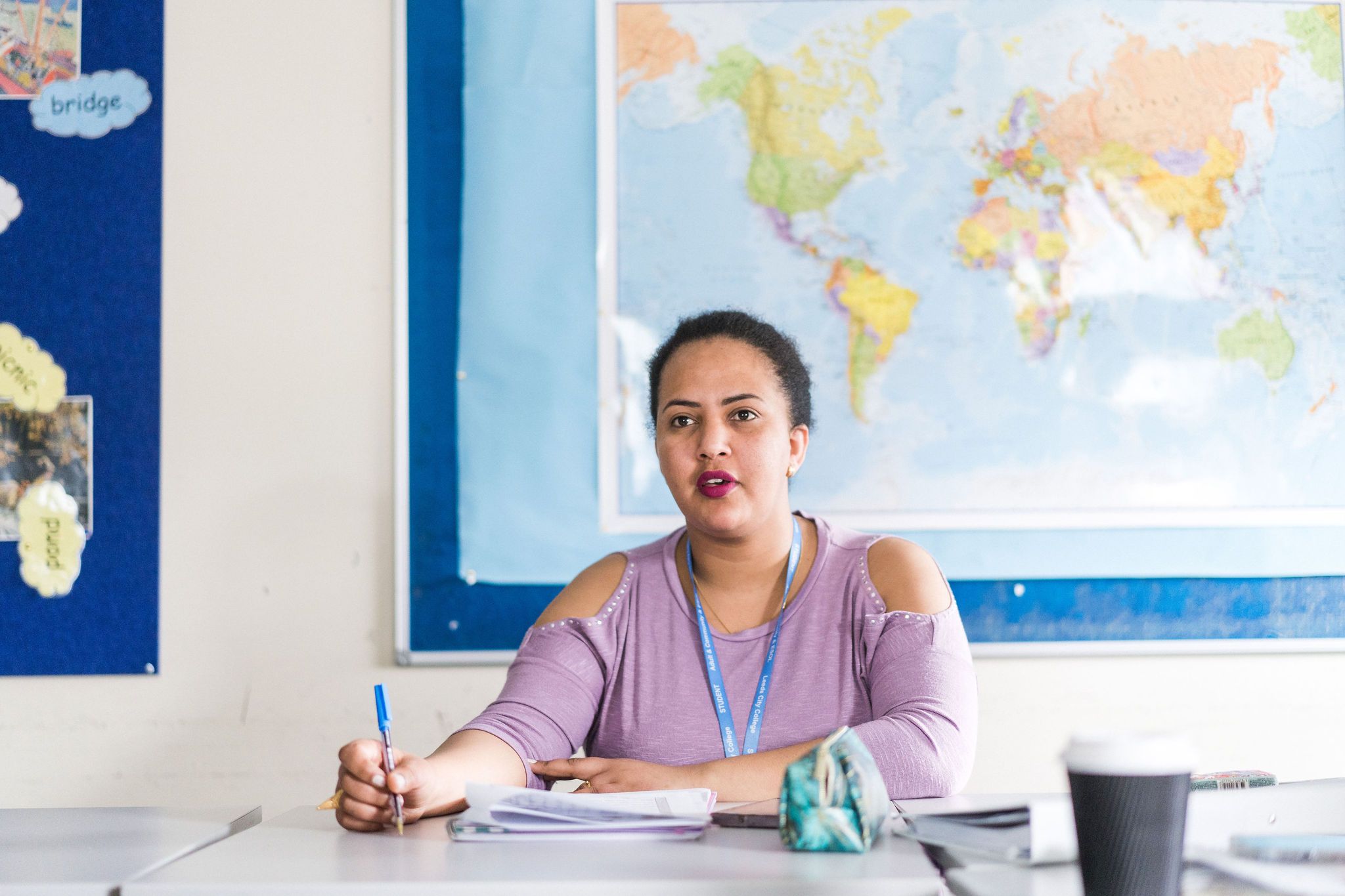 Adult learner in Enfield studying in class writing notes