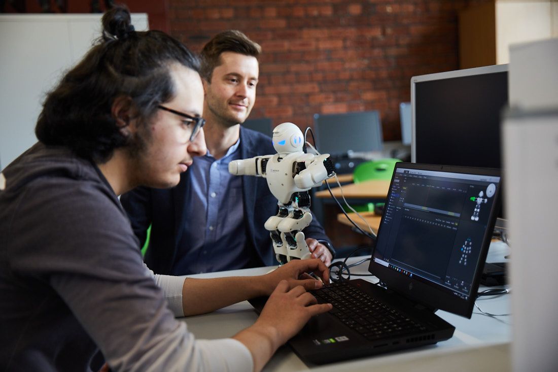 A digital and IT student working on coding to get the robot moving