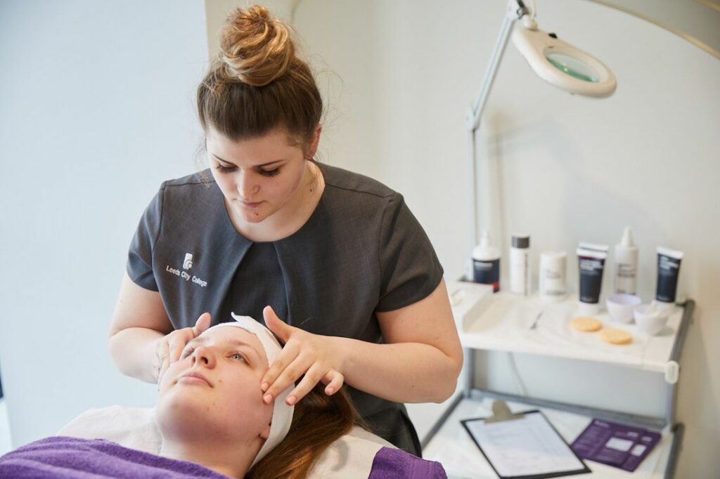 LCC Hair and Beauty student giving a facial massage to a client