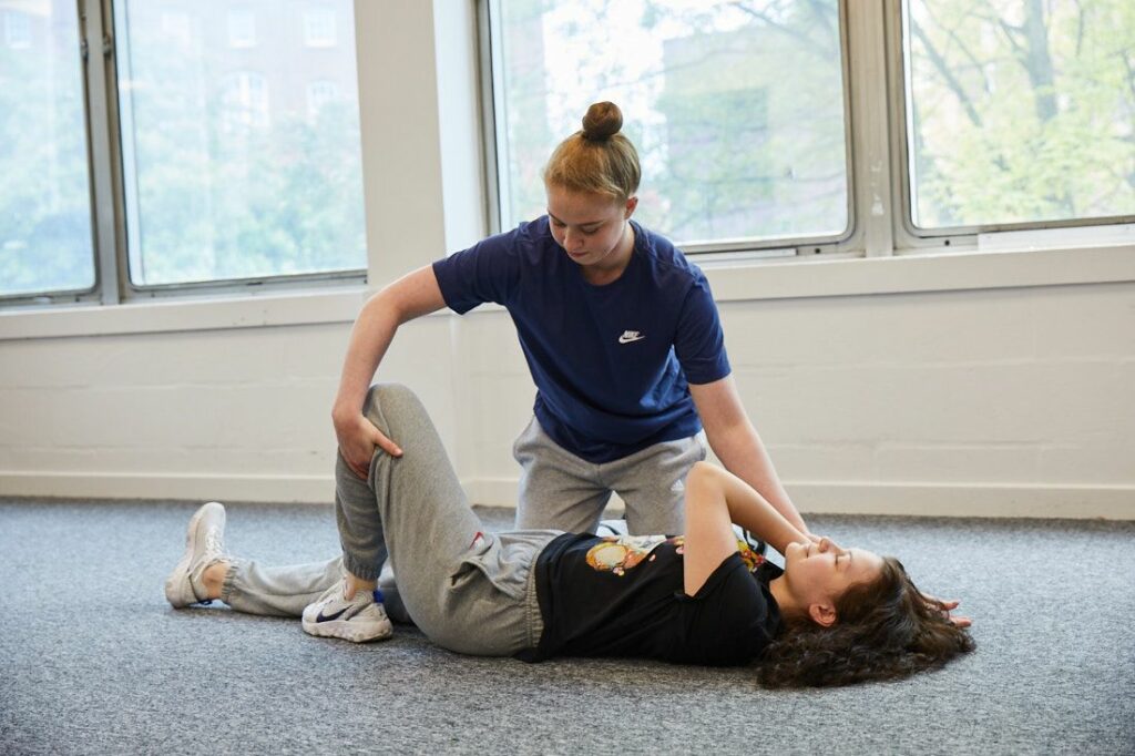Sports therapy student working on a client that has leg pain