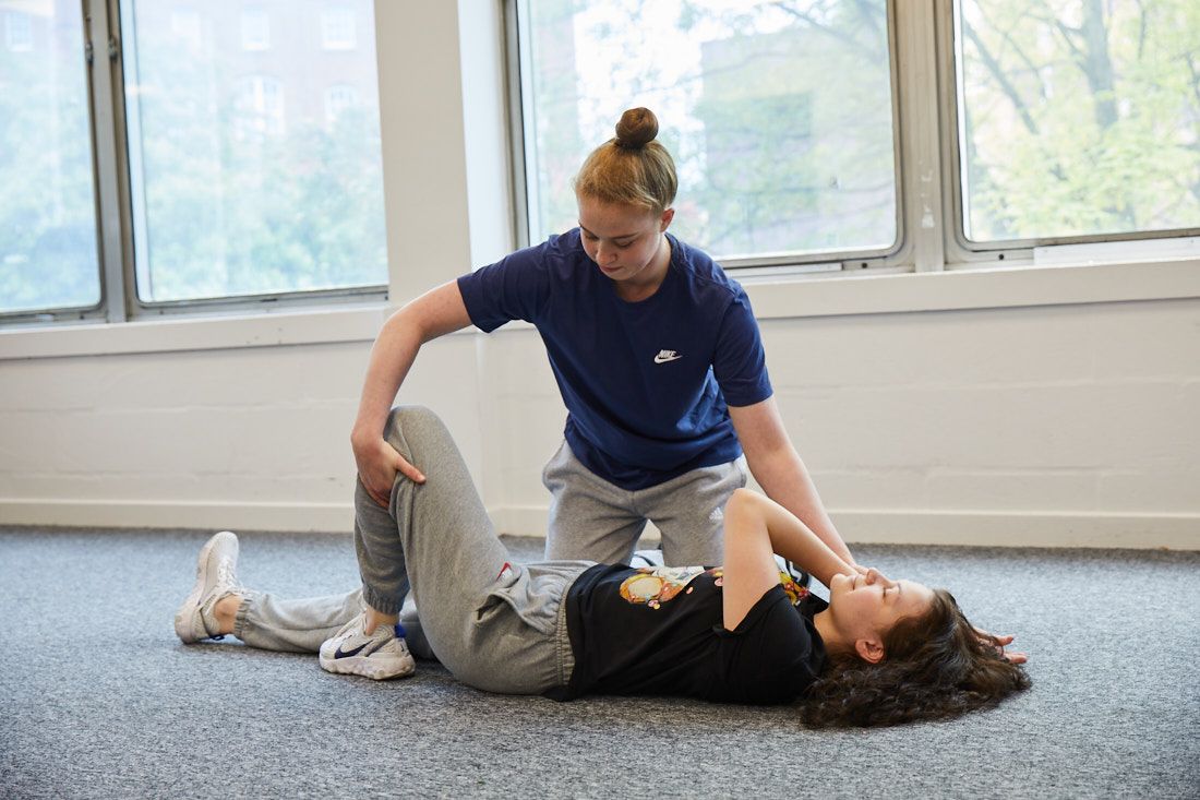 Sports therapy student working on a client that has leg pain