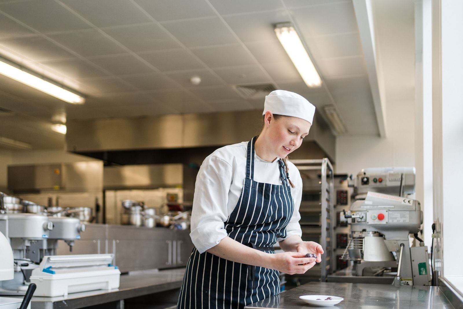 Student chef preparing berries for a dish