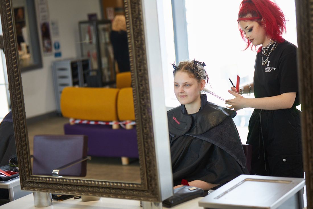 Hair and beauty student styling a clients hair