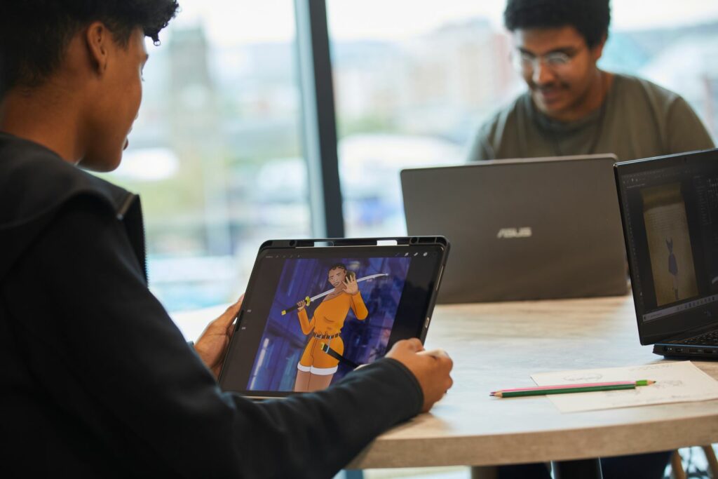 Games Design students creating character designs using iPads