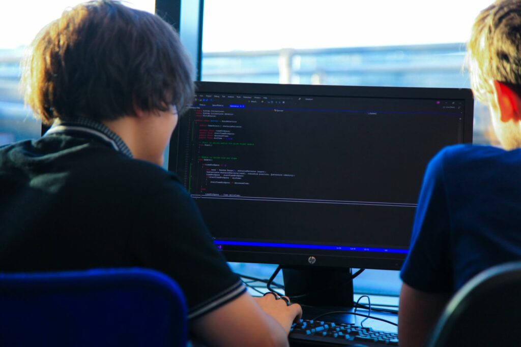 Leeds City College Game Design students working as a pair to code a game
