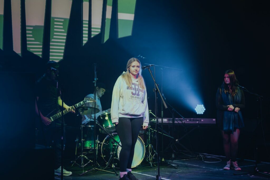 Full band about to play a live show with two lead female singers, male drummer and guitarist