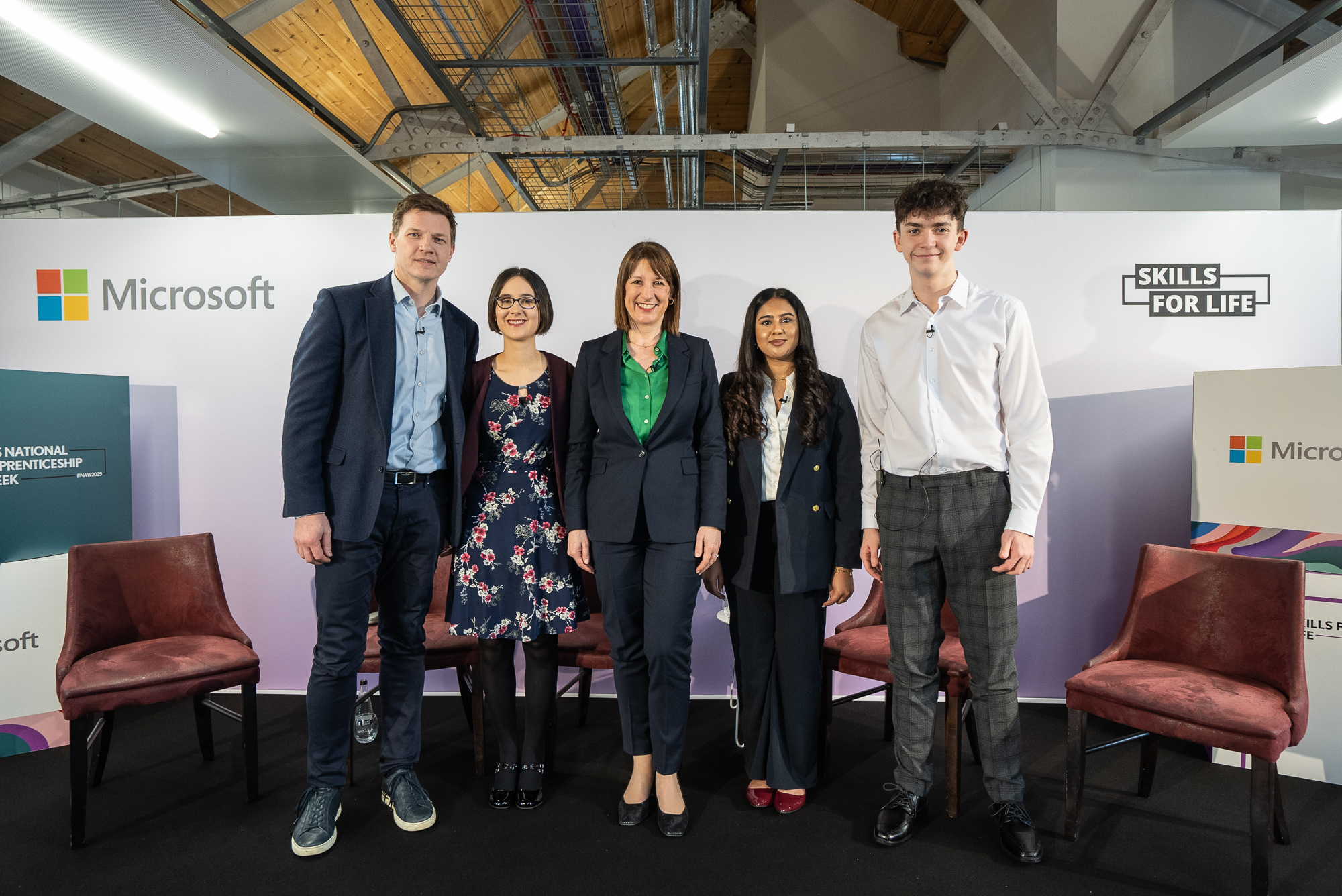 Leeds City College staff and students stood by Microsoft and Skills for Life signage at the National Apprenticeship Week 2025