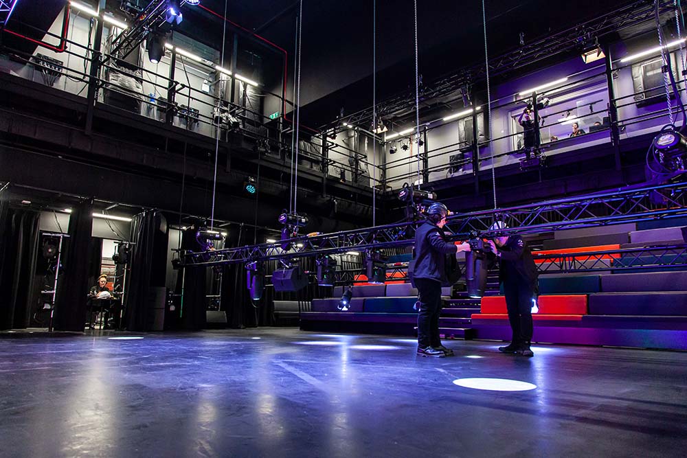Camera technicians checking equipment in the Chroma Q Theatre at Quarry Hill Creative Arts