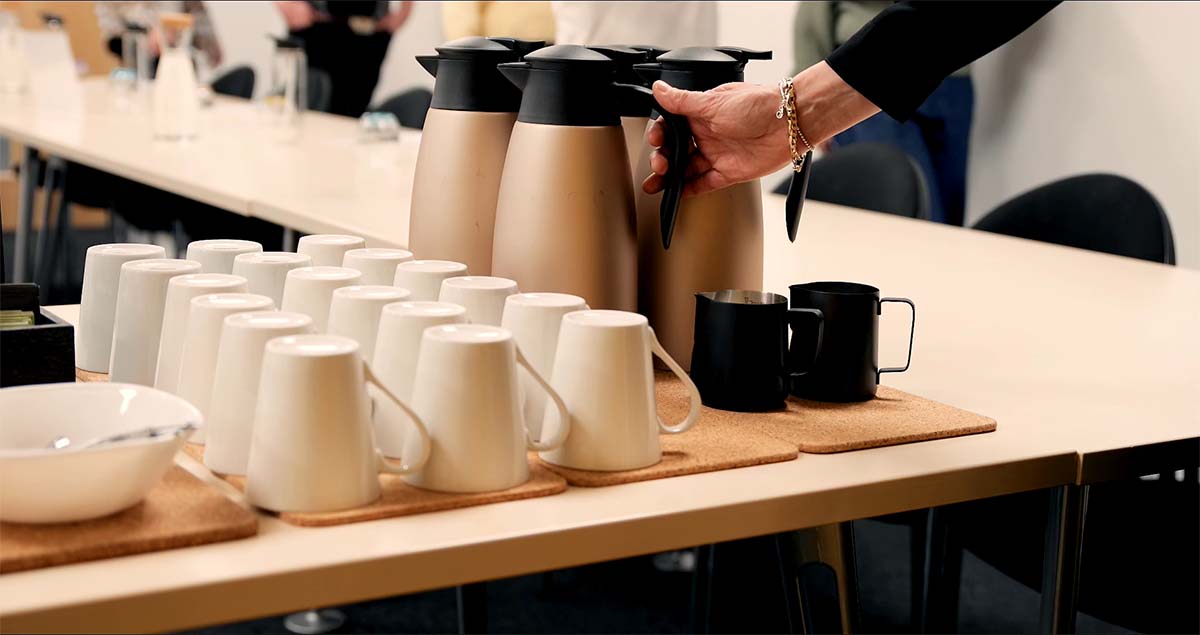 Coffee and tea next to mugs on a table ready to be served at an employers event